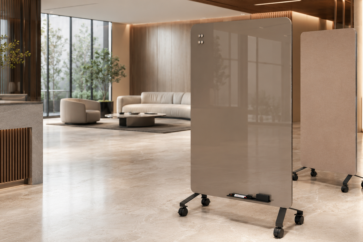 Two tall, glossy beige rolling room dividers with black caster wheels, shown in a modern, sunlit office lobby.